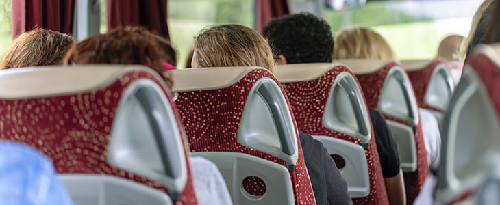 Passengers sit in a charter bus on a tour