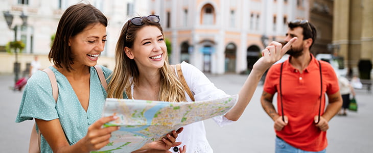 Tourists navigate a city with a map