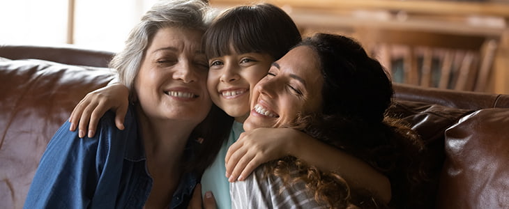 A family hugging and laughing together.