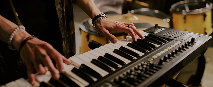 A musician plays a keyboard at a concert