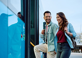 Two passengers approach a bus