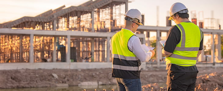 Construction employees talking at site