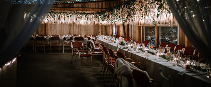 A dinner venue with tables set for a formal event