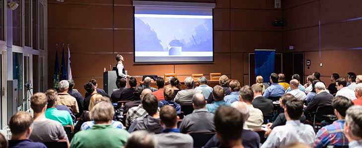 A government official holds a public meeting at a conference